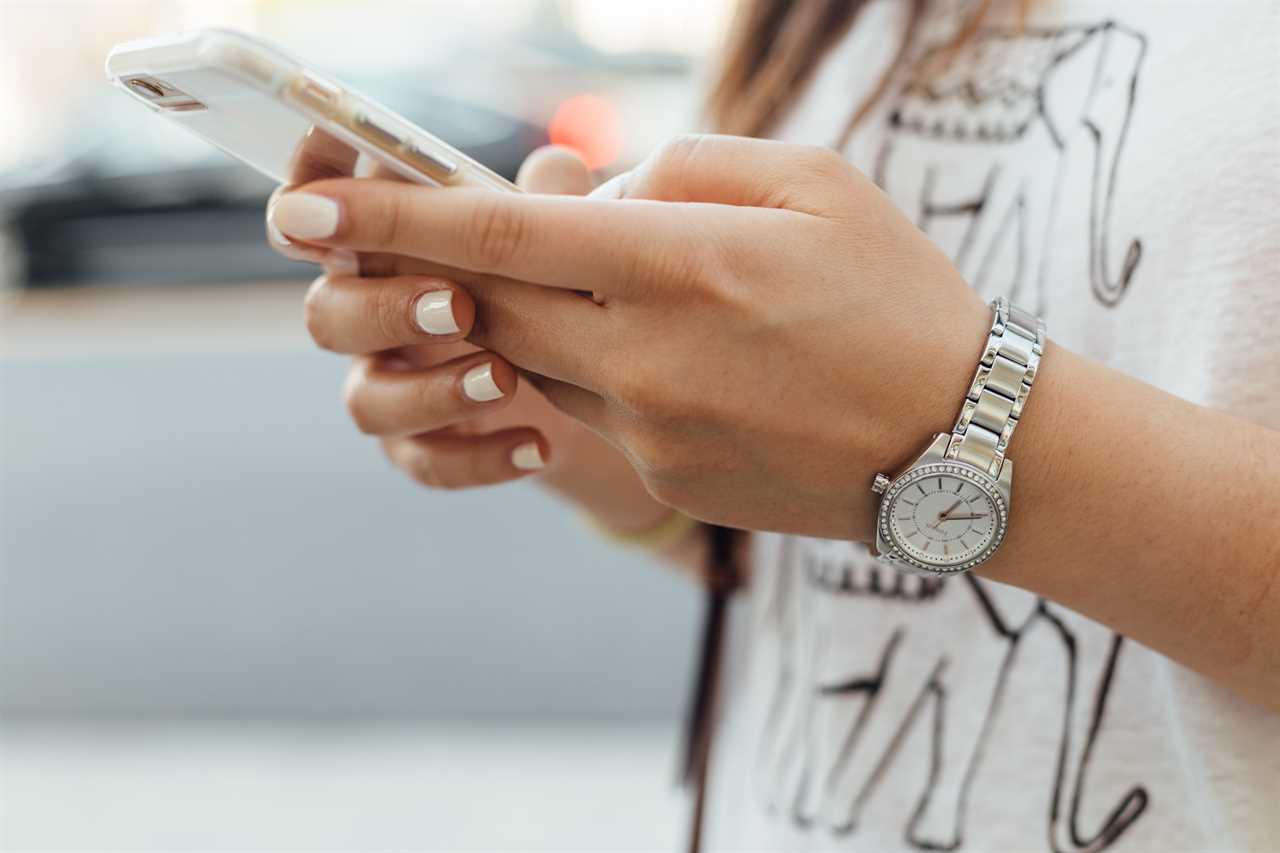 woman's hands using a smartphone
