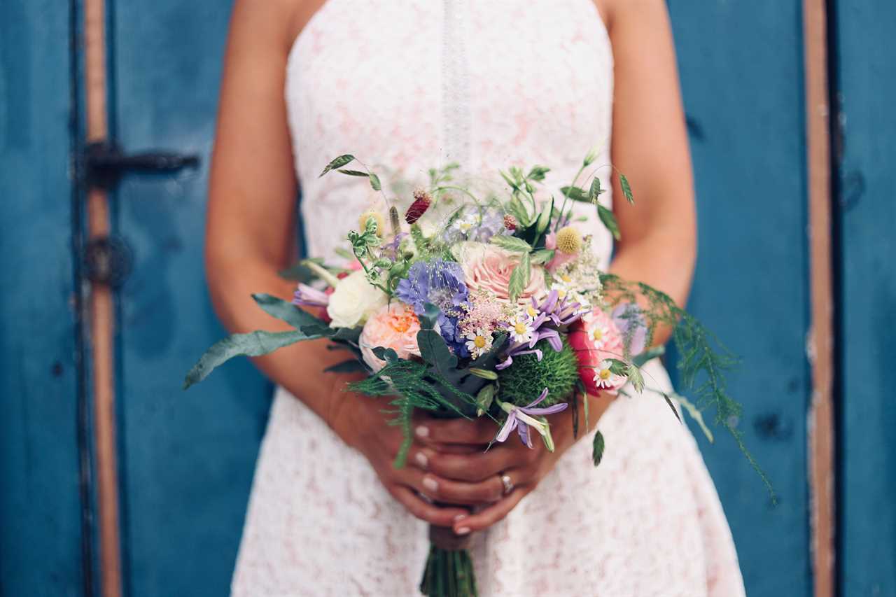 bride holds colourful bouquet of flowers