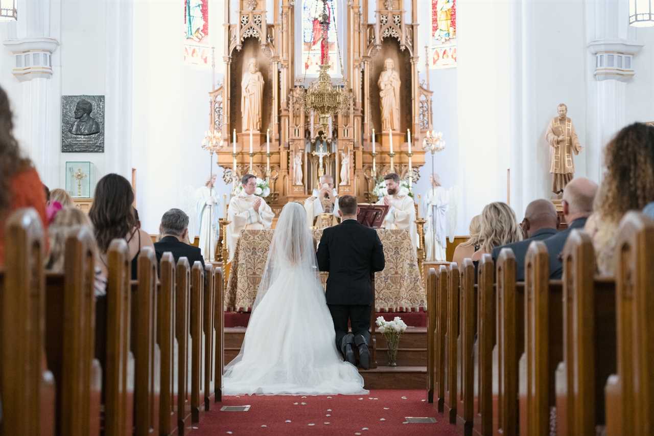 bride and groom at the alter for a roman catholic wedding ceremony