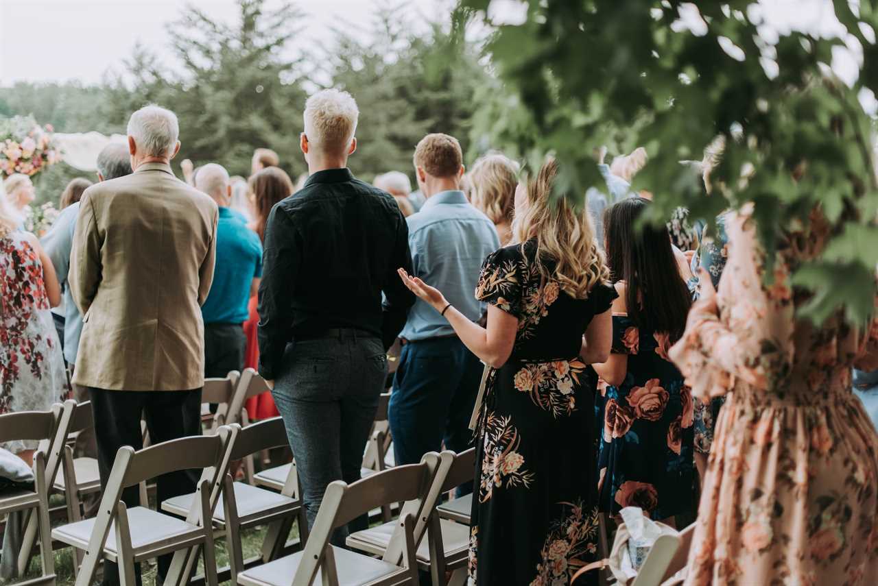 wedding guests standing together at outdoor wedding ceremony