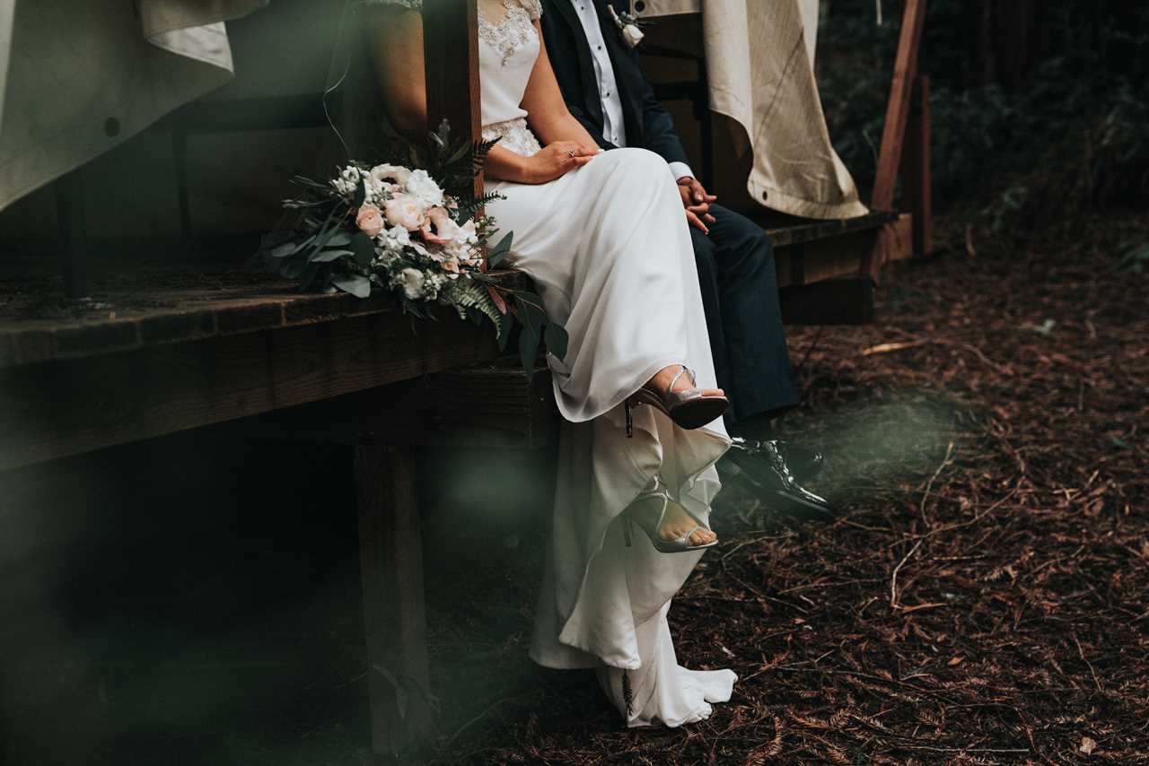 Bride siting with groom on a porch outdoors